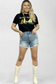 Rhinestone lightwash distressed shorts styed with a graphic tee and white boots