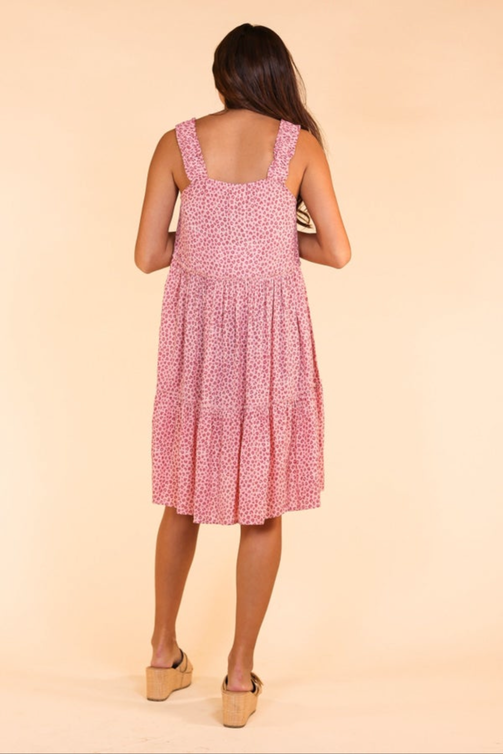 Brunette woman modeling the back view of Lexington and Gray Boutique Wild Ones Pink Leopard Tiered Dress . 