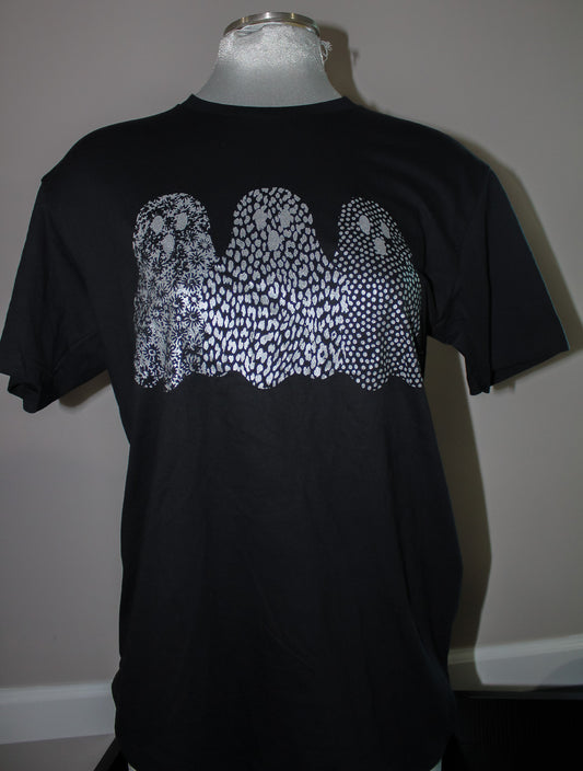 A black short-sleeve t-shirt displayed on a mannequin torso, featuring a large white graphic of three ghosts made of dense dots and lines across the chest.